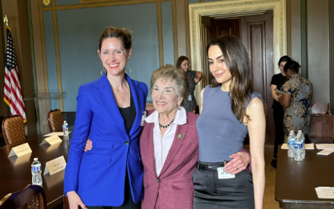 Standing with two women